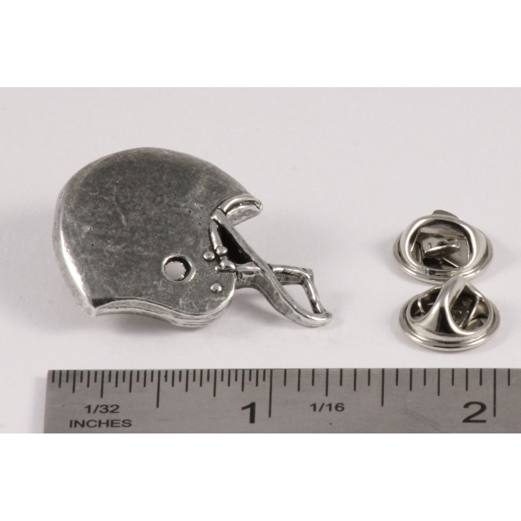 A handcrafted Football Helmet Pin next to a ruler, available for sale at Creativeartisan.com - the image offers a sense of scale