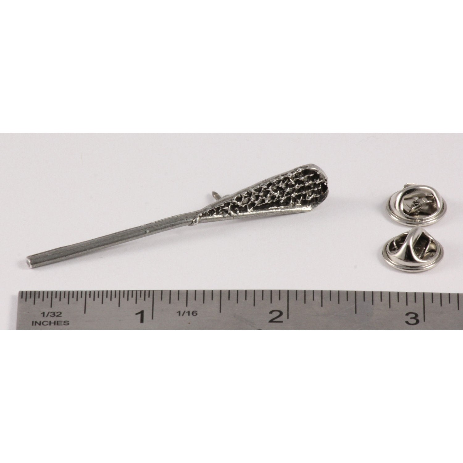 A handcrafted La Crosse Native Stick Pin next to a ruler, available for sale at Creativeartisan.com - the image offers a sense of scale