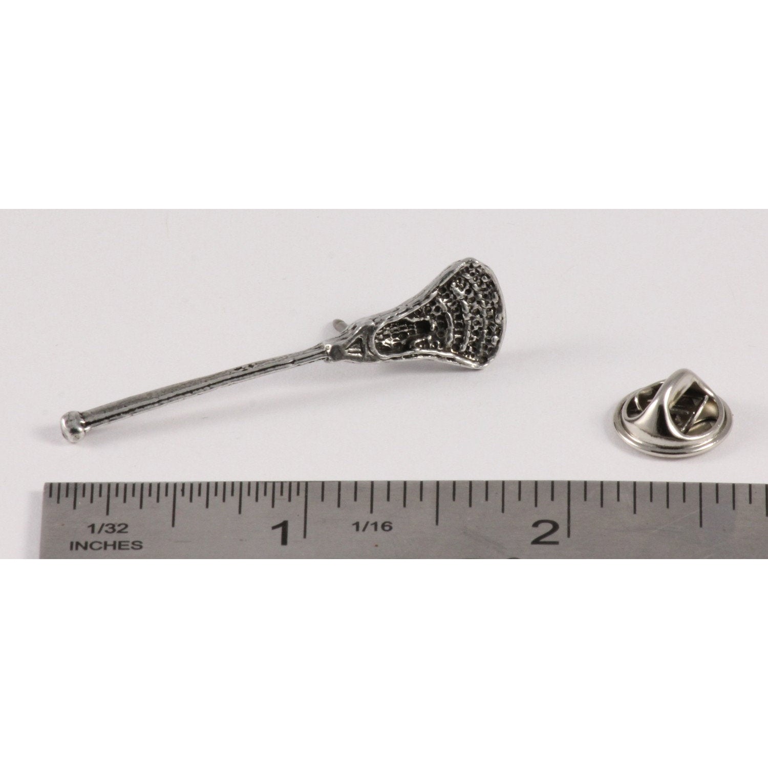A handcrafted La Crosse Modern Stick Pin next to a ruler, available for sale at Creativeartisan.com - the image offers a sense of scale