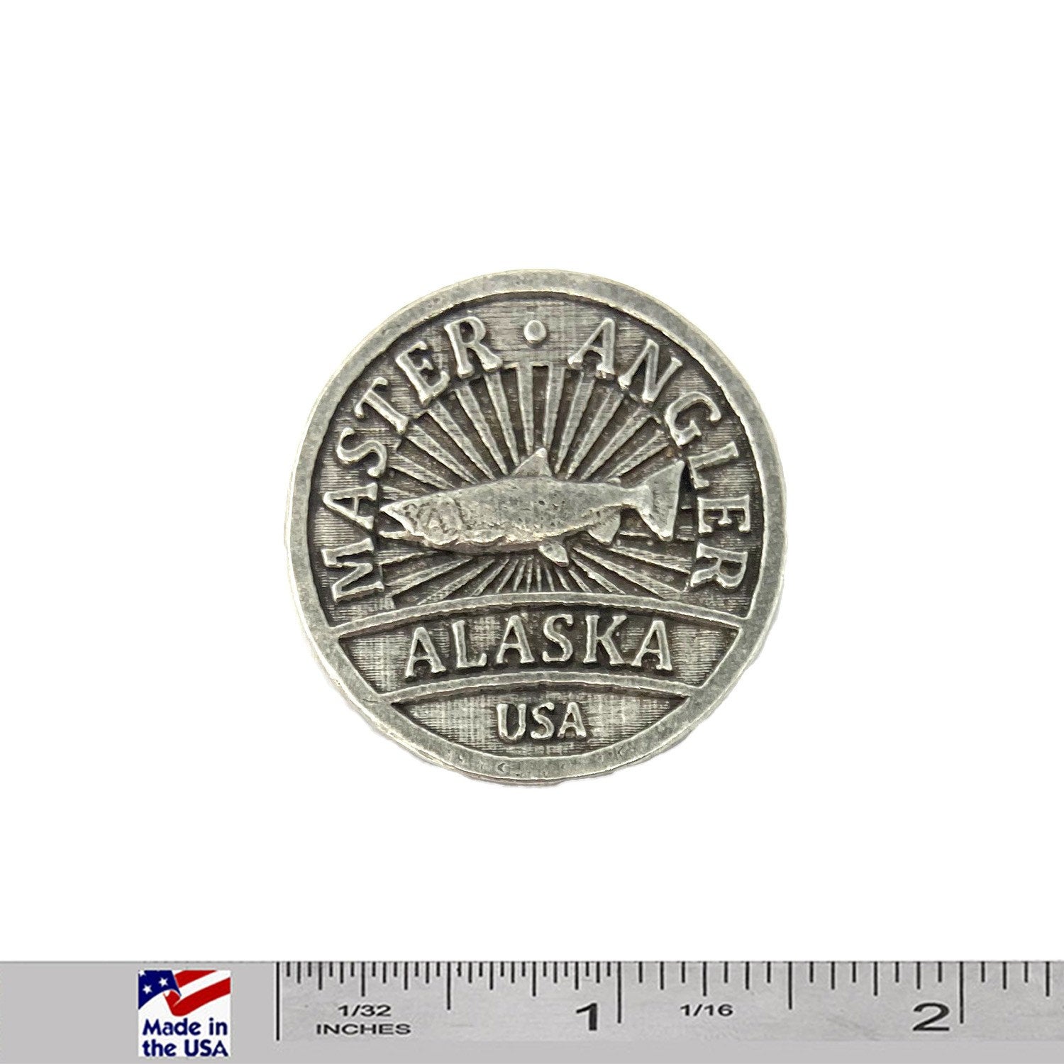 A handcrafted Alaska Master Angler Pin next to a ruler, available for sale at Creativeartisan.com - the image offers a sense of scale
