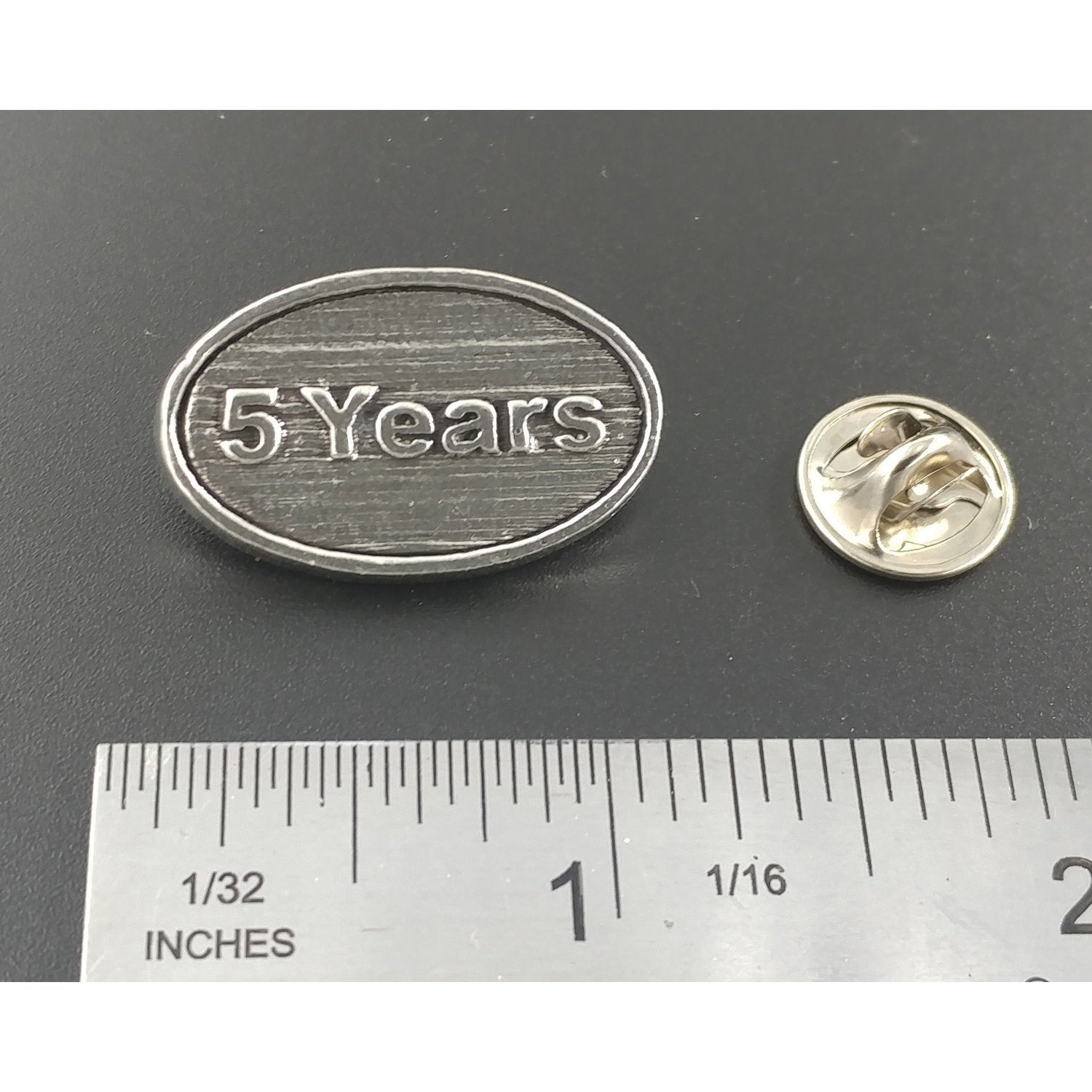A handcrafted 5 Year Pin next to a ruler, available for sale at Creativeartisan.com - the image offers a sense of scale