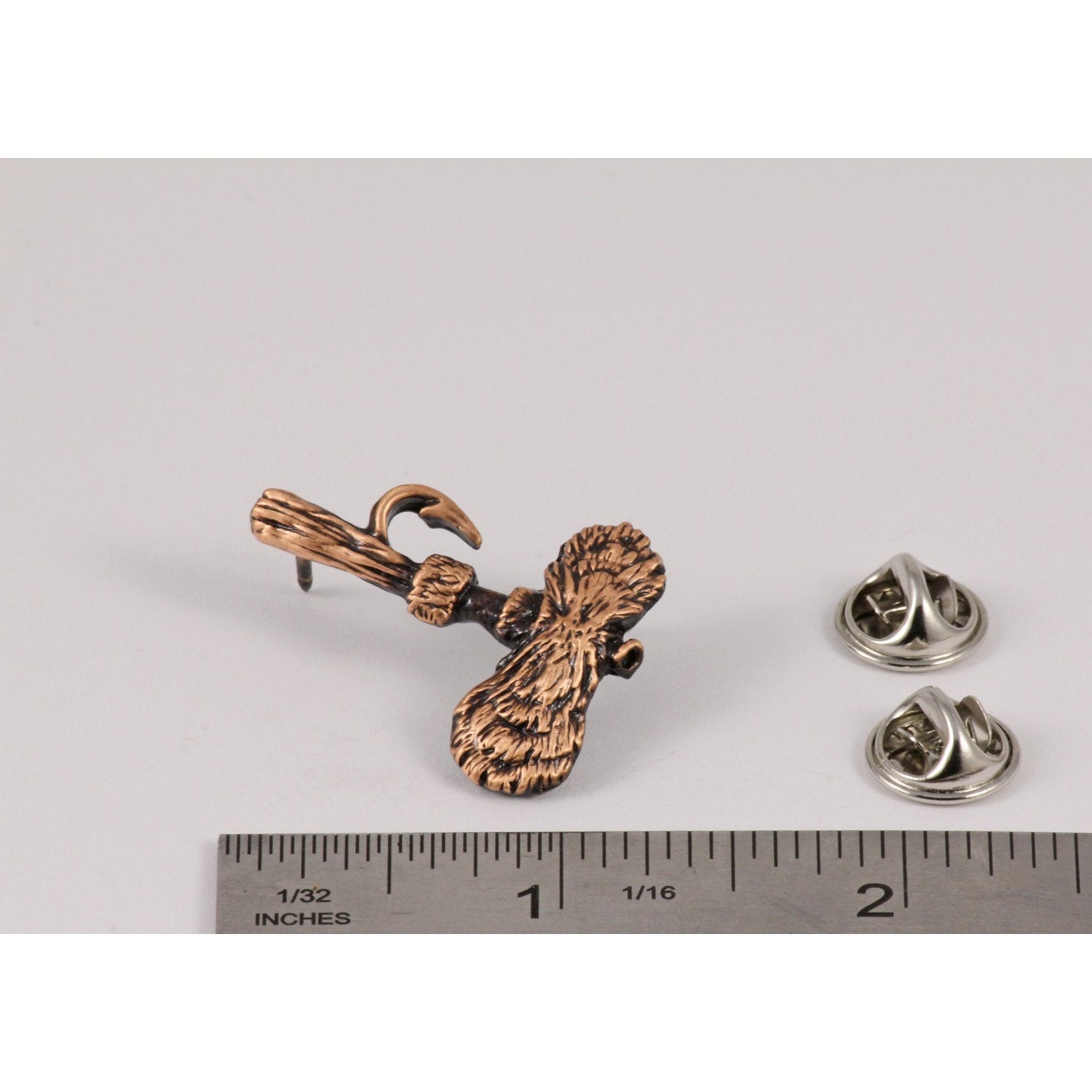 A handcrafted Royal Wulff Fly Pin next to a ruler, available for sale at Creativeartisan.com - the image offers a sense of scale