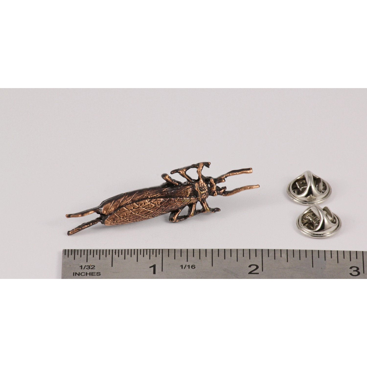 A handcrafted Salmon Fly Insect Pin next to a ruler, available for sale at Creativeartisan.com - the image offers a sense of scale