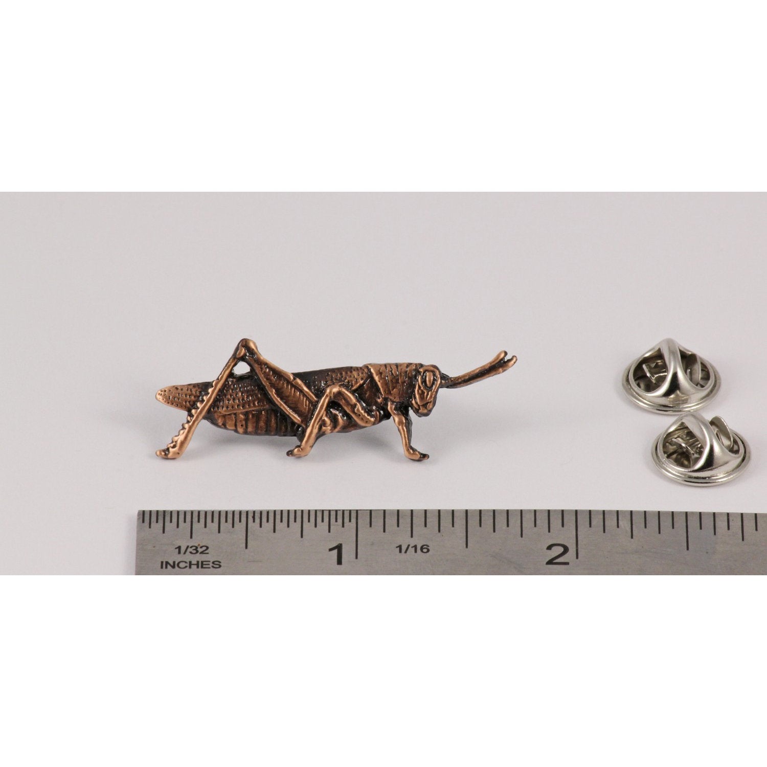 A handcrafted Halibut Alaska Pin next to a ruler, available for sale at Creativeartisan.com - the image offers a sense of scale