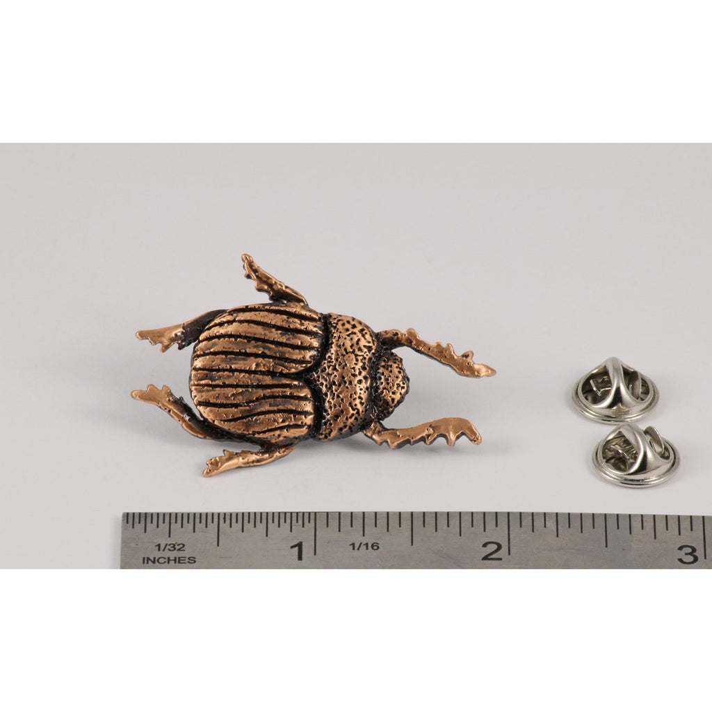 A handcrafted Beatle Pin next to a ruler, available for sale at Creativeartisan.com - the image offers a sense of scale