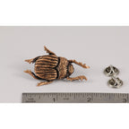 A handcrafted Beatle Pin next to a ruler, available for sale at Creativeartisan.com - the image offers a sense of scale