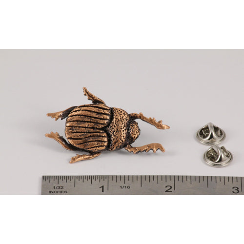 A handcrafted Beatle Pin next to a ruler, available for sale at Creativeartisan.com - the image offers a sense of scale