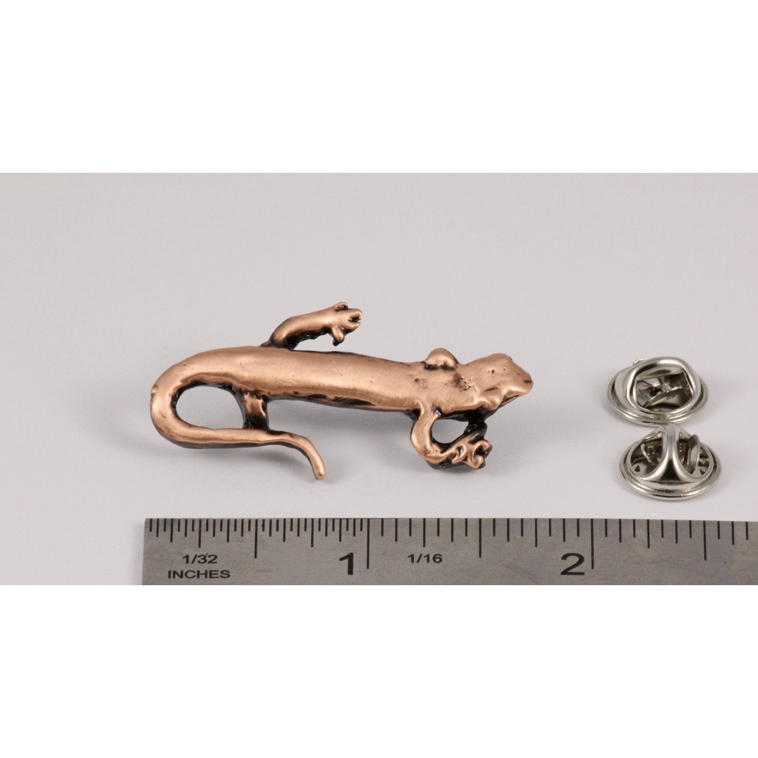 A handcrafted Salamander Pin next to a ruler, available for sale at Creativeartisan.com - the image offers a sense of scale
