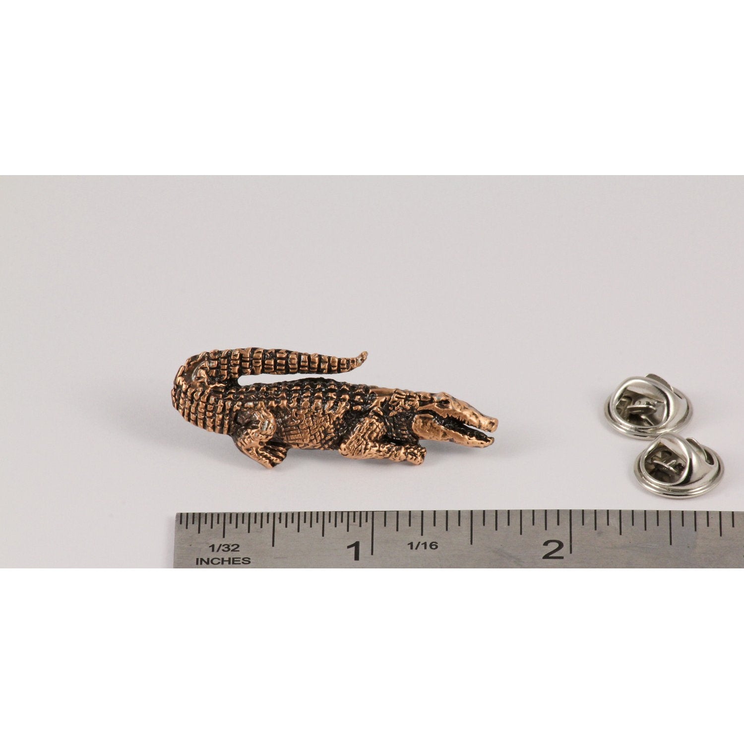 A handcrafted Alligator Pin next to a ruler, available for sale at Creativeartisan.com - the image offers a sense of scale
