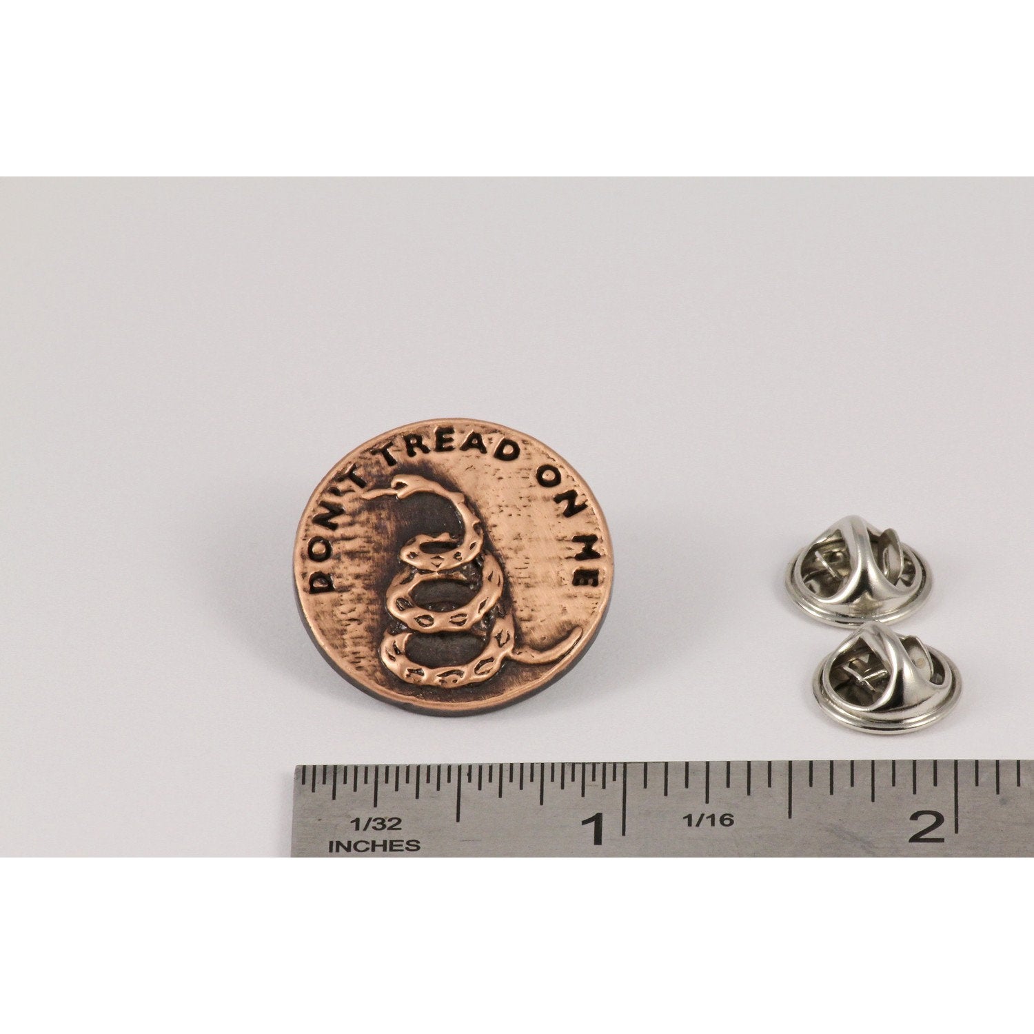 A handcrafted Dont Tread On Me Pin next to a ruler, available for sale at Creativeartisan.com - the image offers a sense of scale