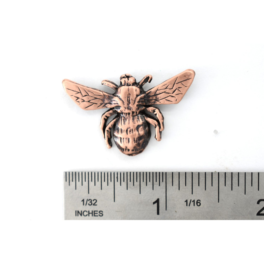 A handcrafted Bumble Bee Top View Pin next to a ruler, available for sale at Creativeartisan.com - the image offers a sense of scale