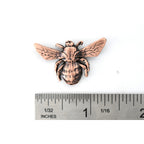 A handcrafted Bumble Bee Top View Pin next to a ruler, available for sale at Creativeartisan.com - the image offers a sense of scale
