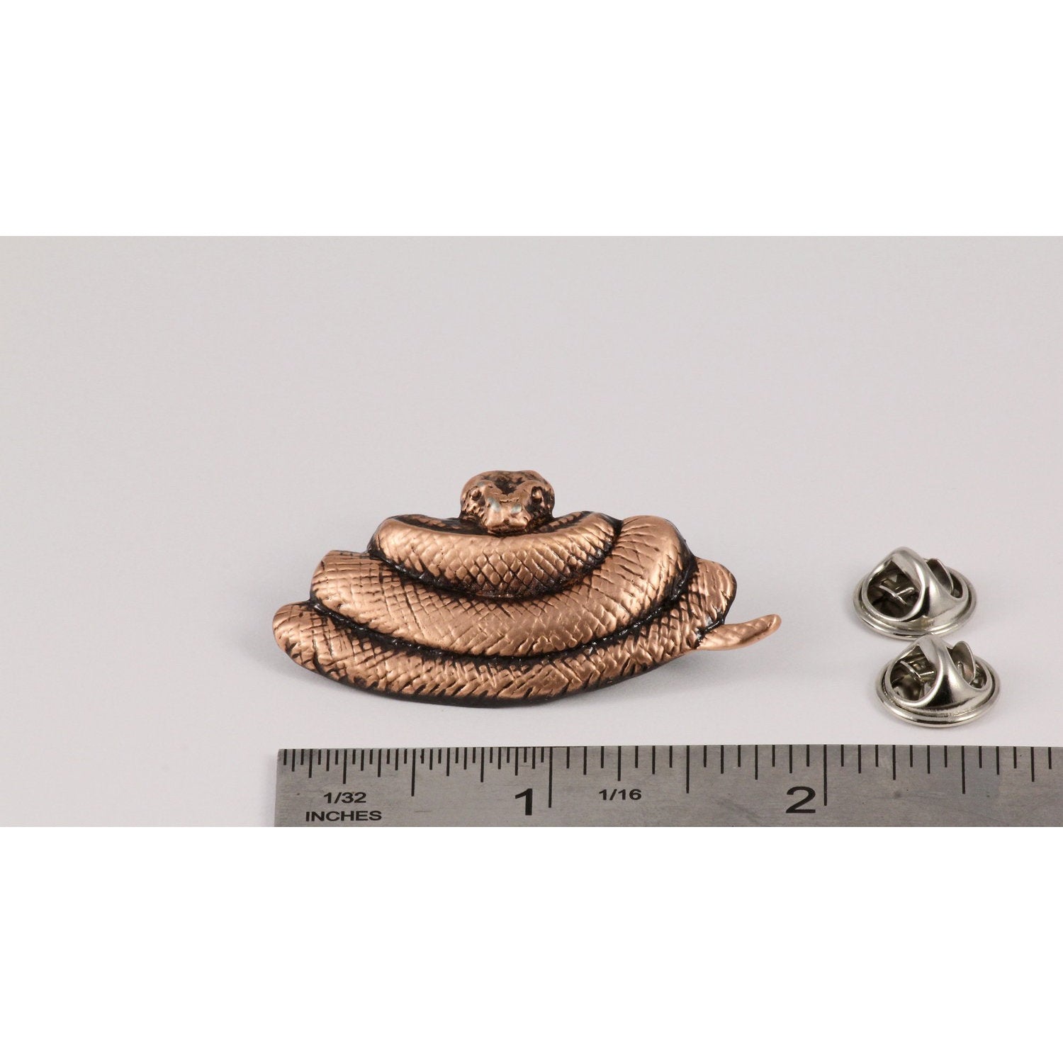 A handcrafted Python Pin next to a ruler, available for sale at Creativeartisan.com - the image offers a sense of scale