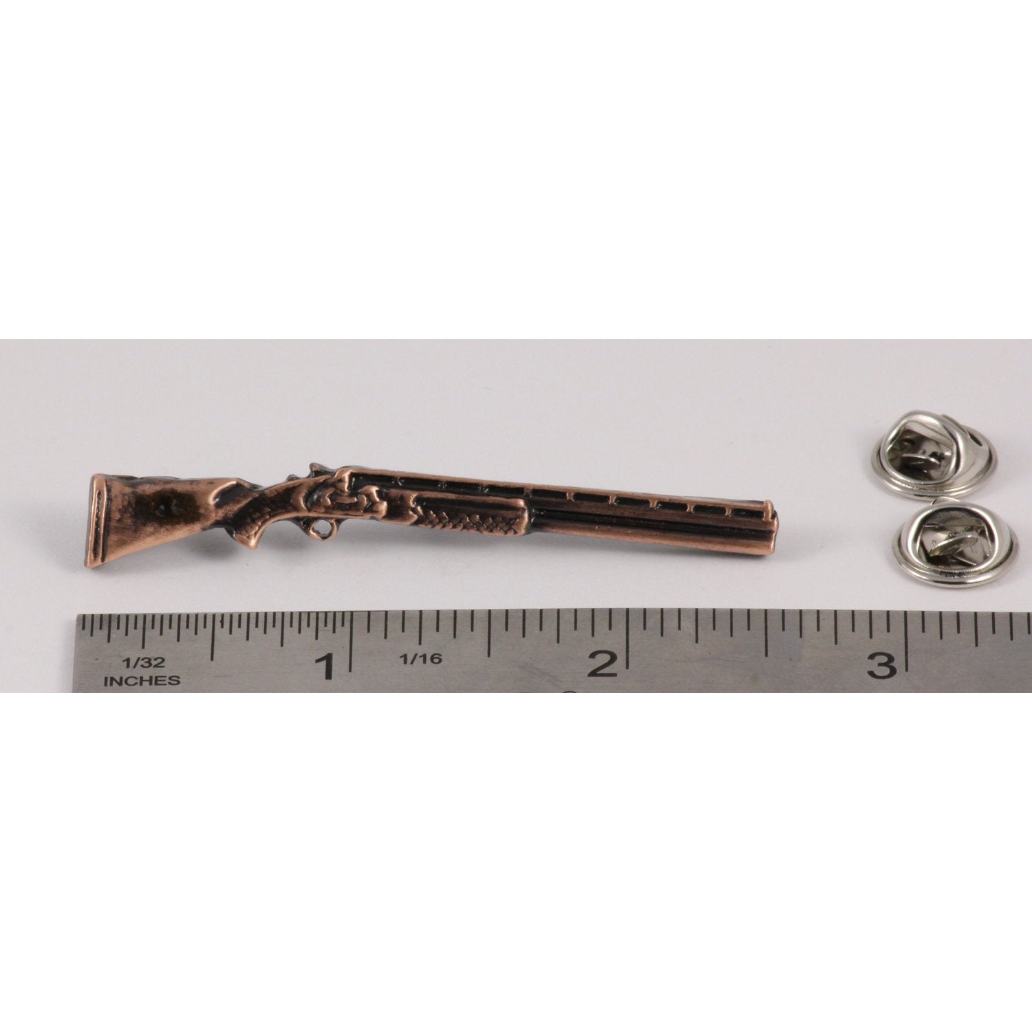 A handcrafted Over Under Shotgun Pin next to a ruler, available for sale at Creativeartisan.com - the image offers a sense of scale