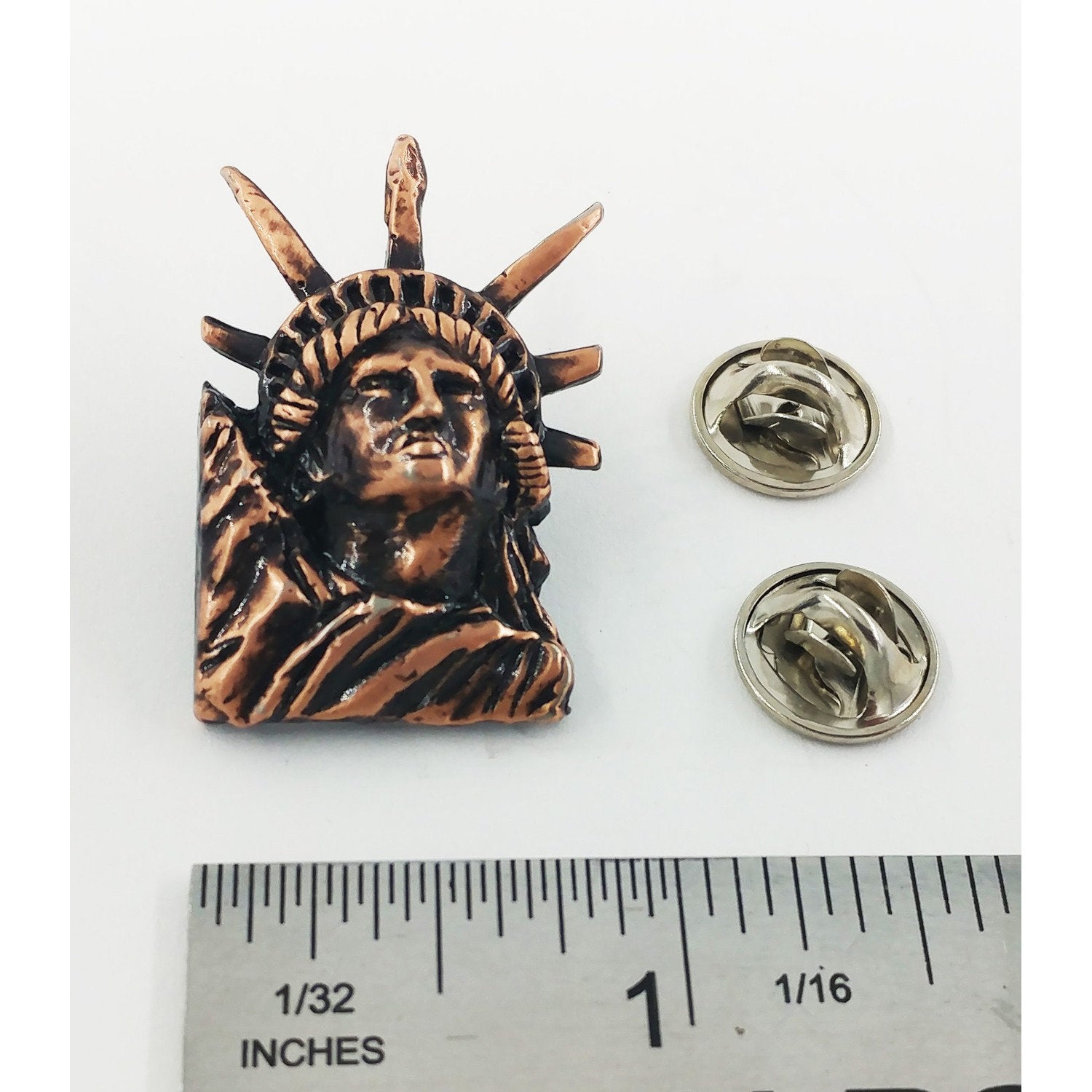 A handcrafted Lady Liberty Pin next to a ruler, available for sale at Creativeartisan.com - the image offers a sense of scale
