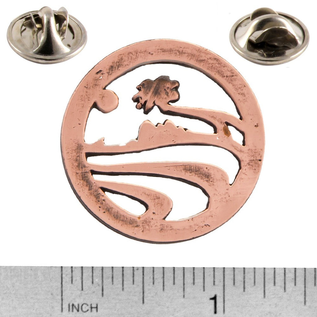 A handcrafted Palm Tree Pin next to a ruler, available for sale at Creativeartisan.com - the image offers a sense of scale