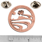 A handcrafted Palm Tree Pin next to a ruler, available for sale at Creativeartisan.com - the image offers a sense of scale