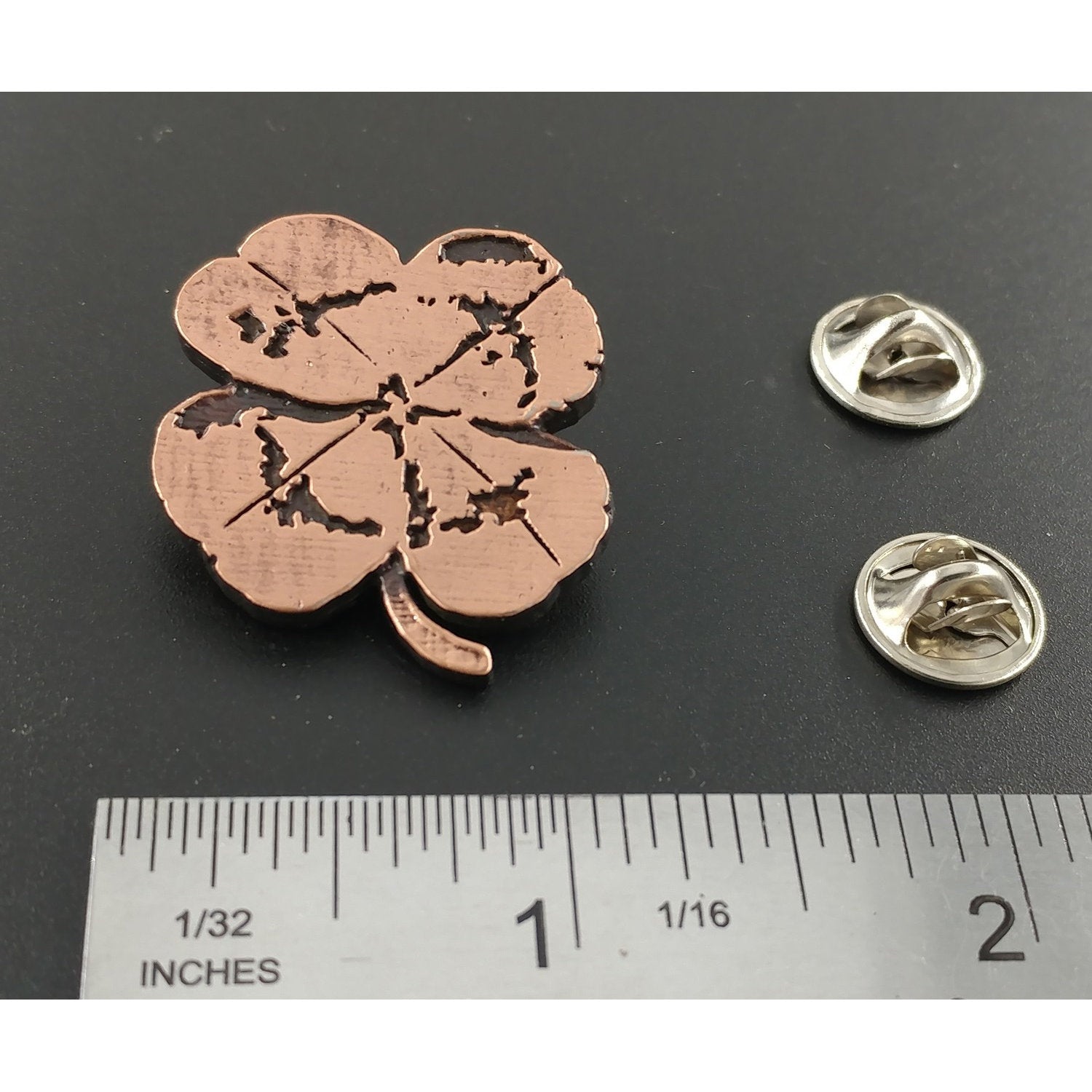 A handcrafted Four Leaf Clover Pin next to a ruler, available for sale at Creativeartisan.com - the image offers a sense of scale