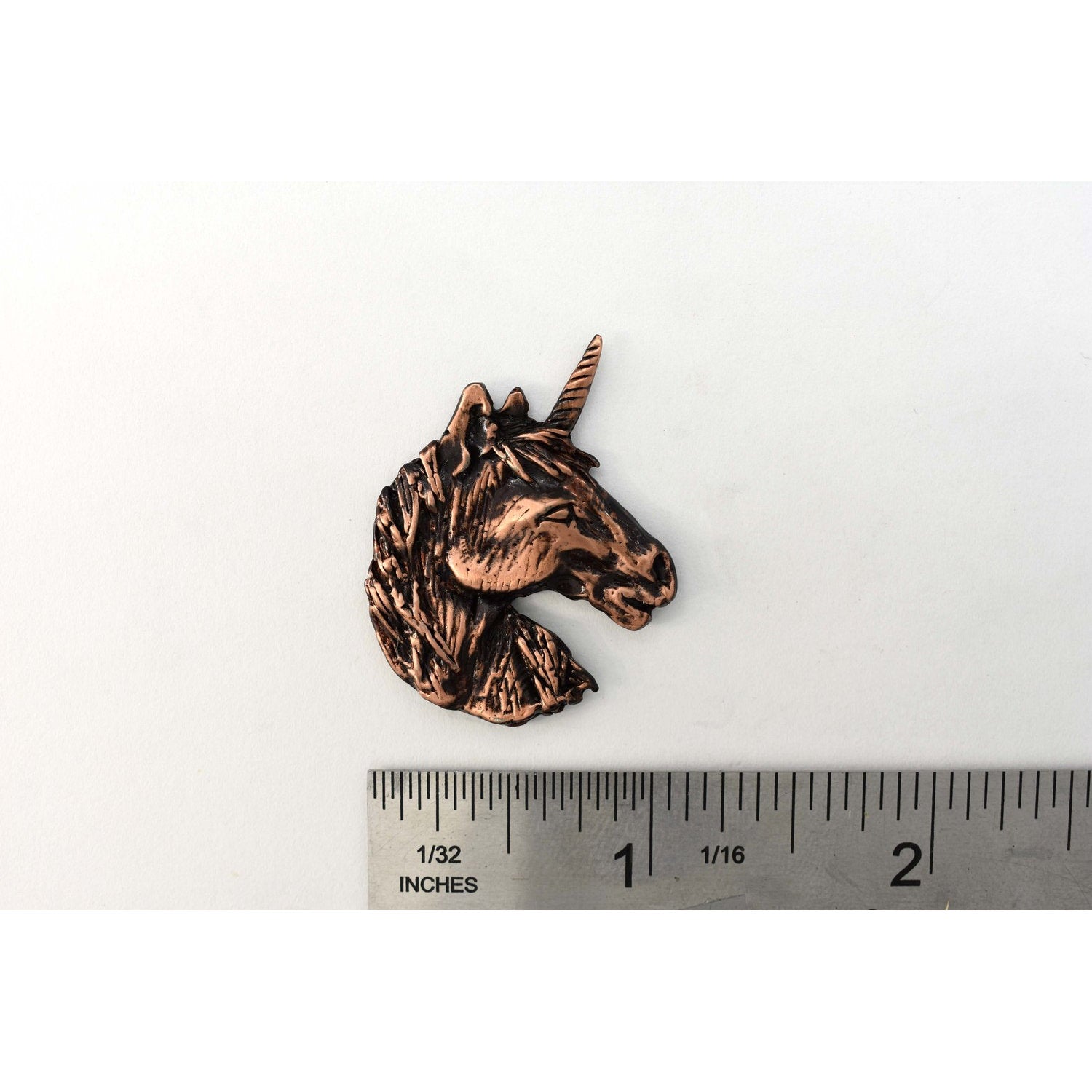 A handcrafted Unicorn Head Pin next to a ruler, available for sale at Creativeartisan.com - the image offers a sense of scale
