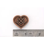 A handcrafted Heart With Celtic Knot Pin next to a ruler, available for sale at Creativeartisan.com - the image offers a sense of scale