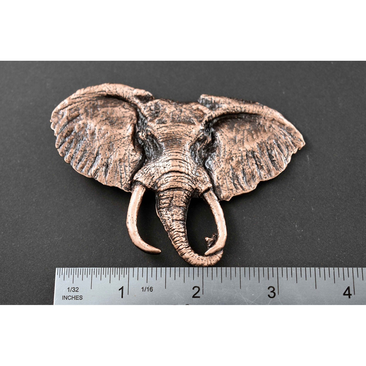 A handcrafted Elephant With Tusks Pin next to a ruler, available for sale at Creativeartisan.com - the image offers a sense of scale