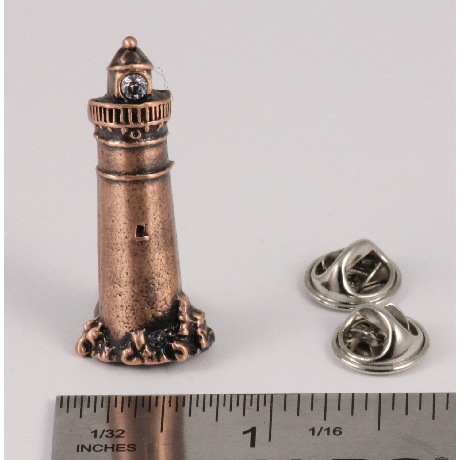 A handcrafted Lighthouse Pin next to a ruler, available for sale at Creativeartisan.com - the image offers a sense of scale