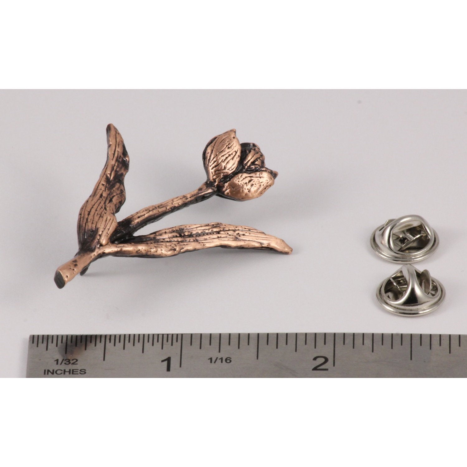 A handcrafted Tulip Pin next to a ruler, available for sale at Creativeartisan.com - the image offers a sense of scale