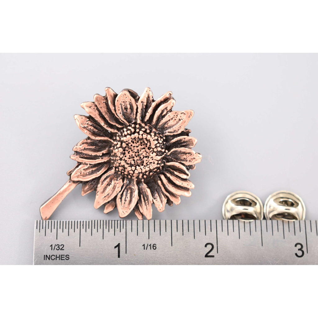 A handcrafted Sunflower Pin next to a ruler, available for sale at Creativeartisan.com - the image offers a sense of scale