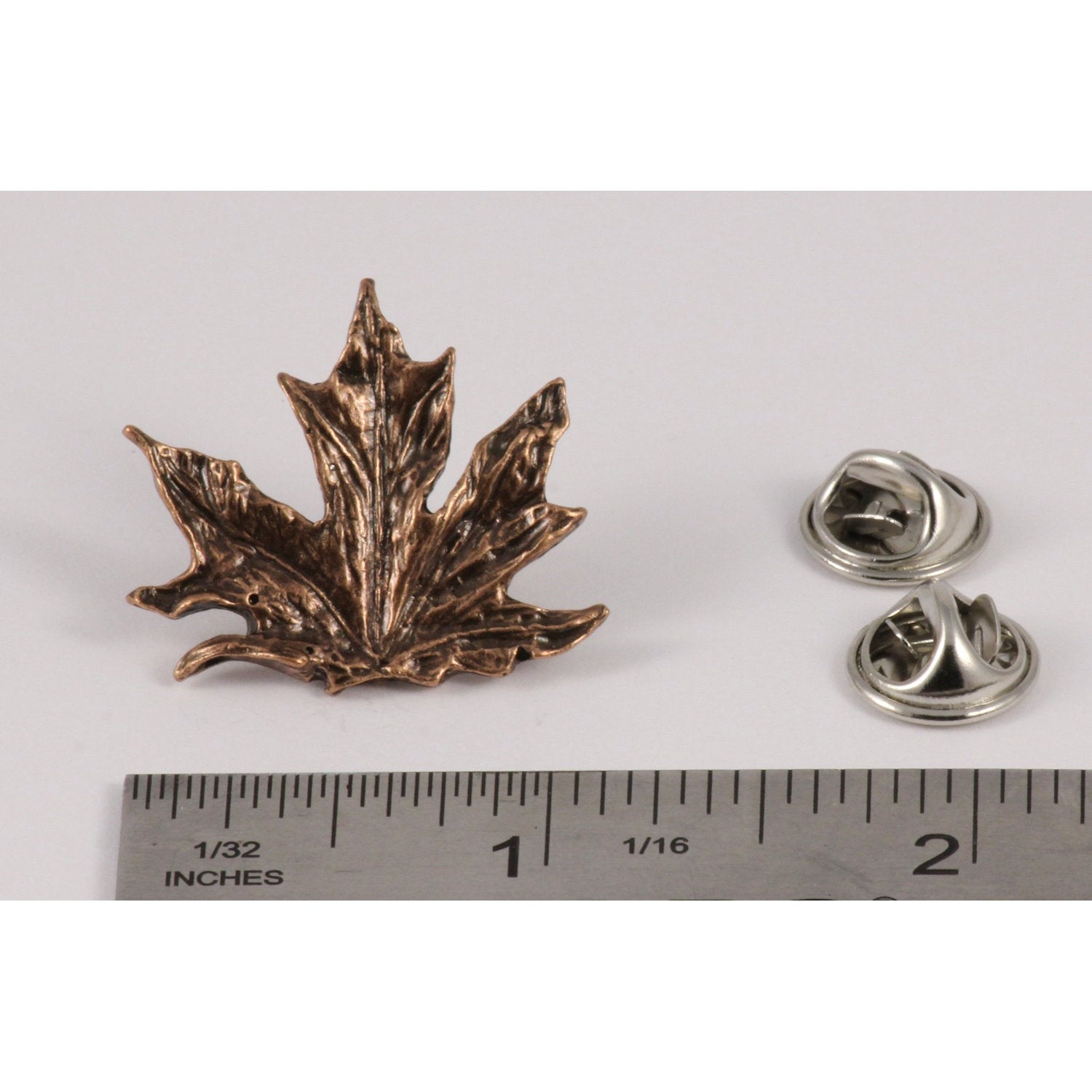 A handcrafted Maple Leaf Pin next to a ruler, available for sale at Creativeartisan.com - the image offers a sense of scale