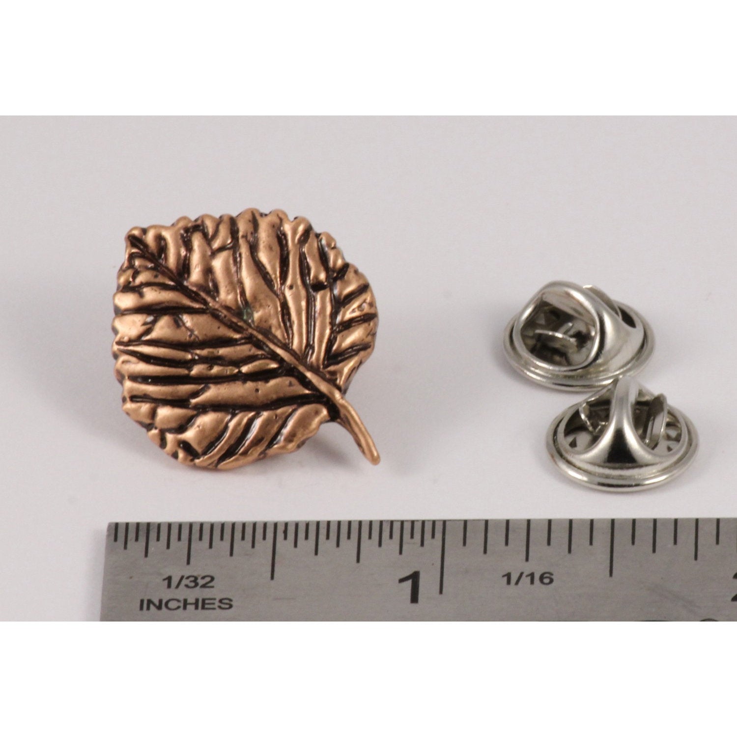A handcrafted Aspen Leaf Pin next to a ruler, available for sale at Creativeartisan.com - the image offers a sense of scale