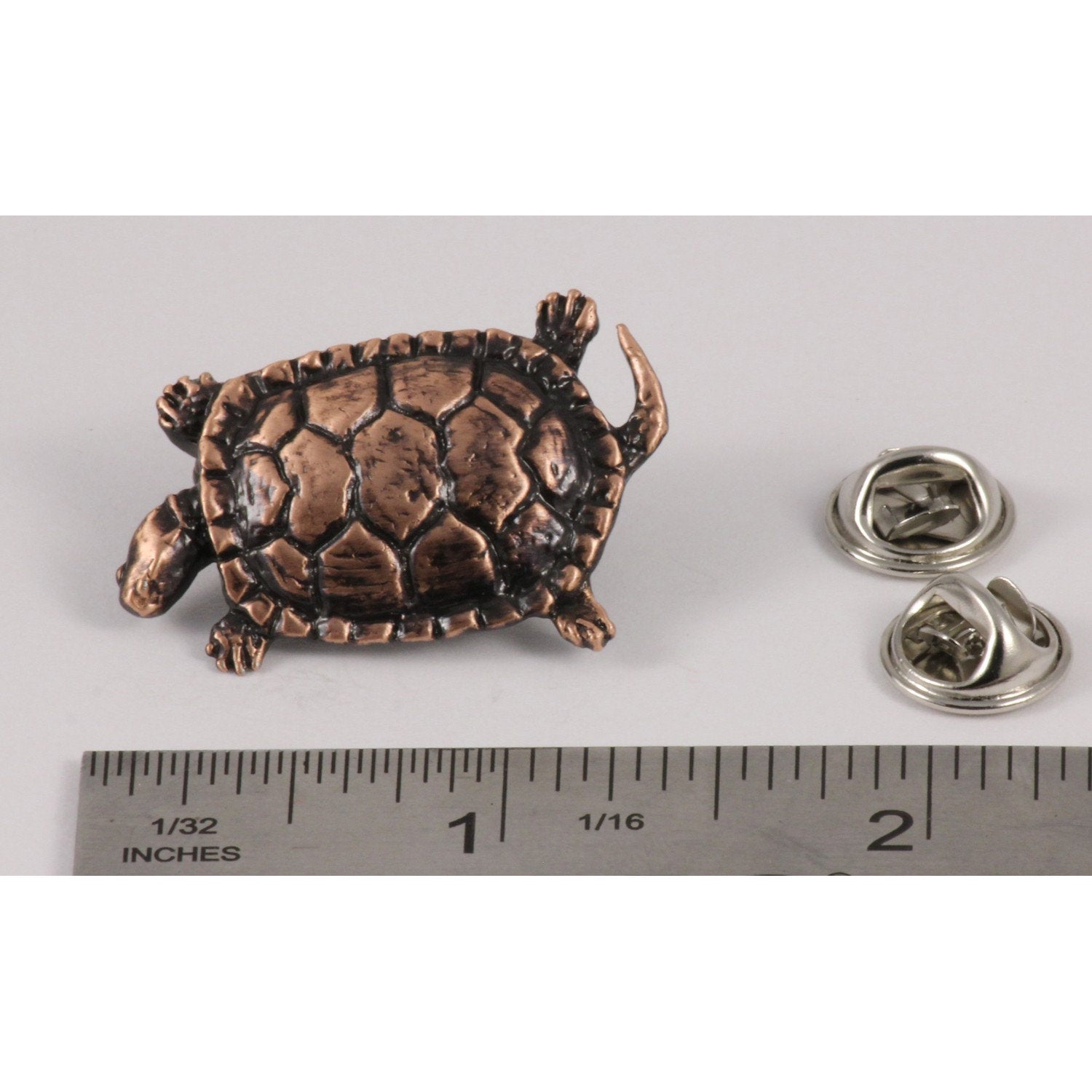A handcrafted Pond Turtle Pin next to a ruler, available for sale at Creativeartisan.com - the image offers a sense of scale