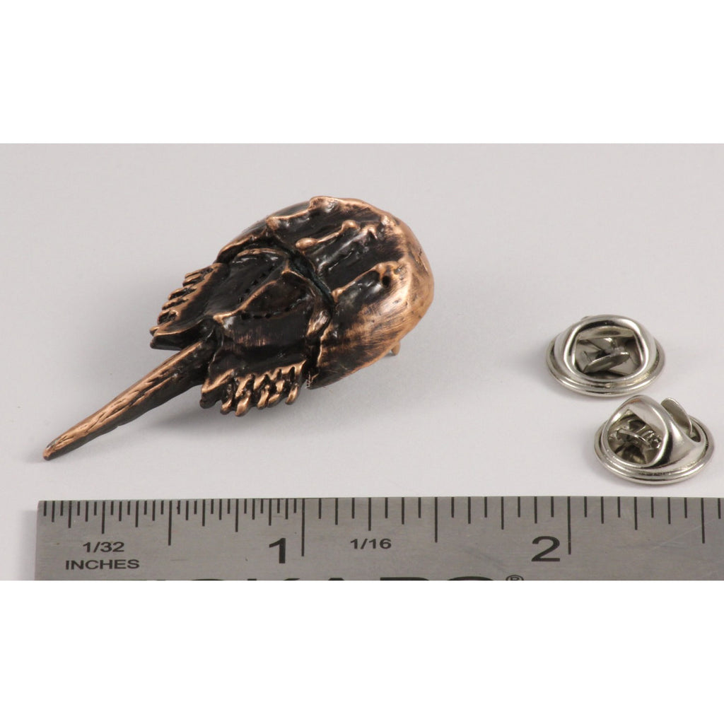 A handcrafted Horseshoe Crab Pin next to a ruler, available for sale at Creativeartisan.com - the image offers a sense of scale