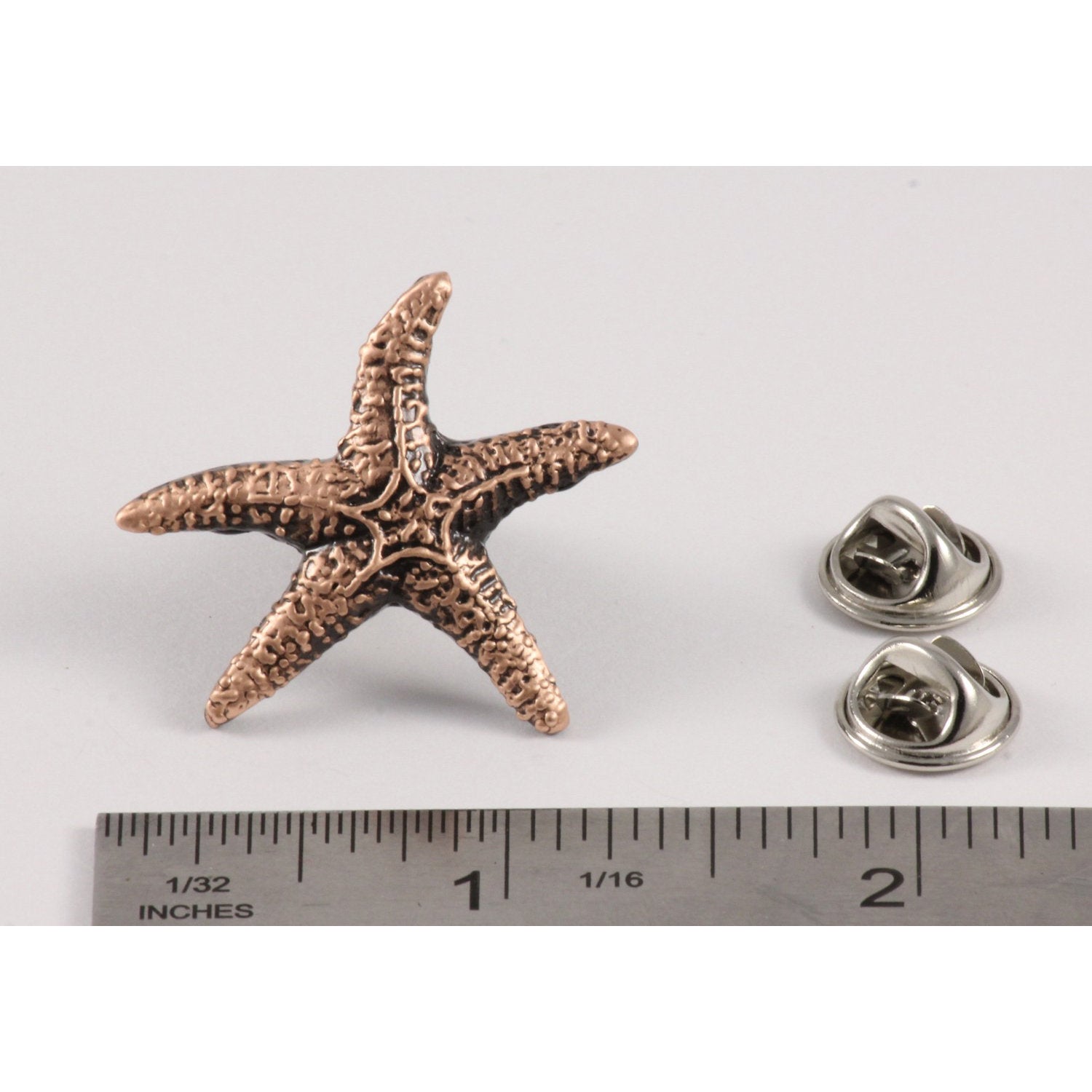 A handcrafted Starfish Pin next to a ruler, available for sale at Creativeartisan.com - the image offers a sense of scale