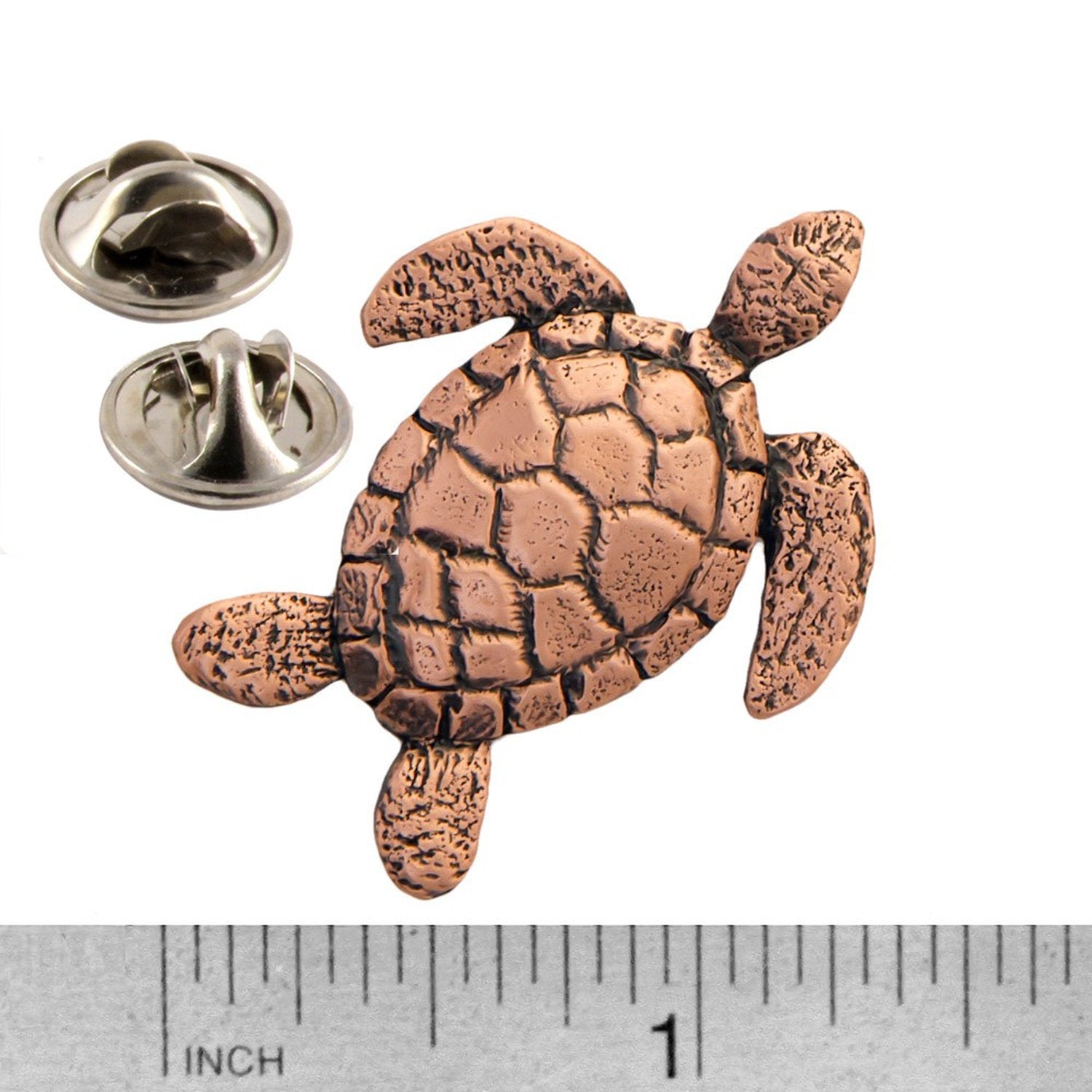 A handcrafted Sea Turtle Top View Pin next to a ruler, available for sale at Creativeartisan.com - the image offers a sense of scale