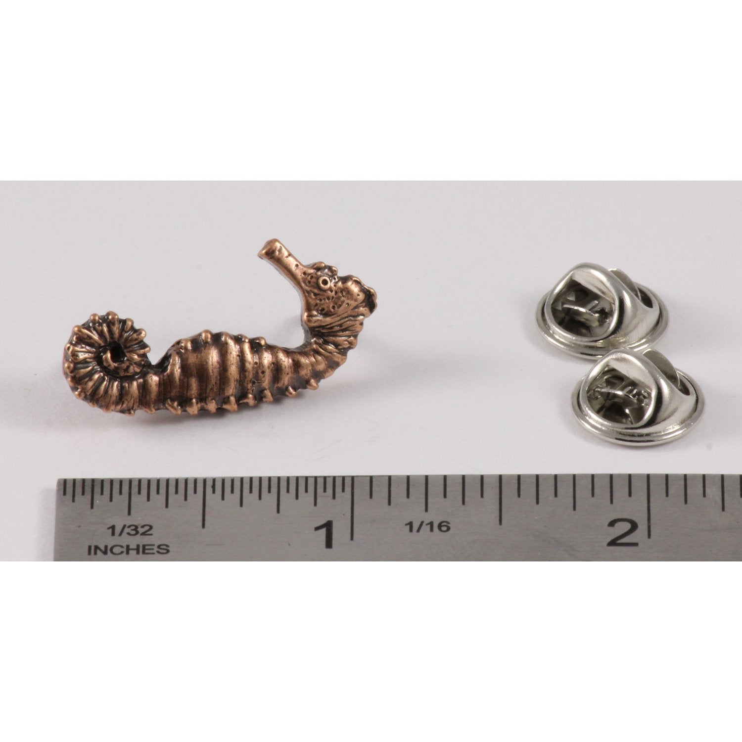 A handcrafted Sea Star Pin next to a ruler, available for sale at Creativeartisan.com - the image offers a sense of scale