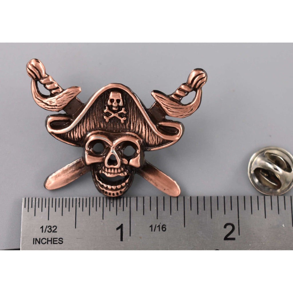 A handcrafted Pirate Head Pin next to a ruler, available for sale at Creativeartisan.com - the image offers a sense of scale