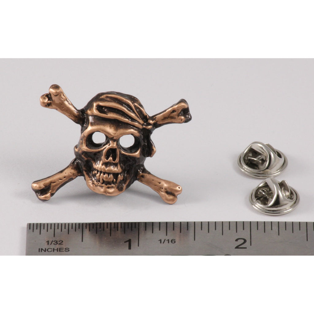 A handcrafted Pirate Skull Crossbones Pin next to a ruler, available for sale at Creativeartisan.com - the image offers a sense of scale