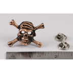 A handcrafted Pirate Skull Crossbones Pin next to a ruler, available for sale at Creativeartisan.com - the image offers a sense of scale