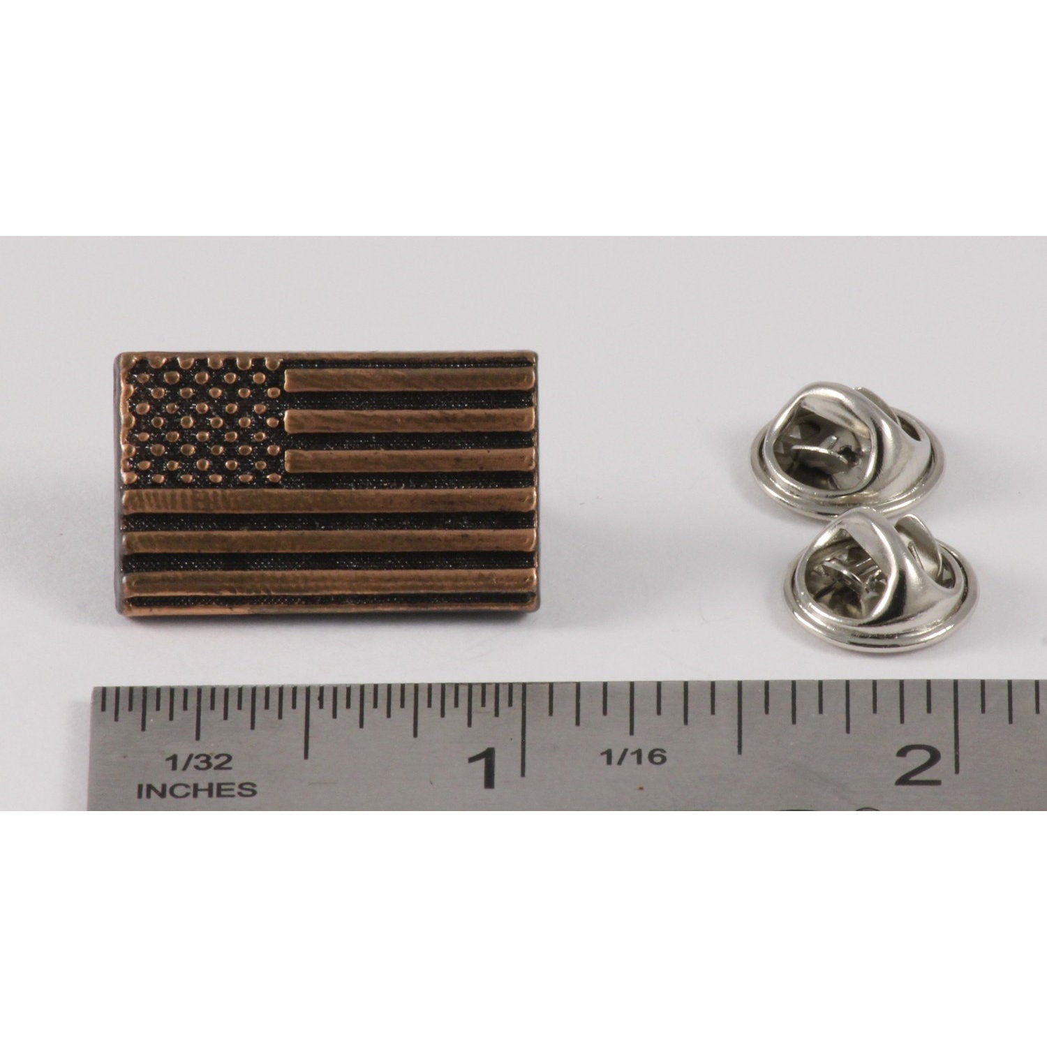 A handcrafted American Flag Profile Pin next to a ruler, available for sale at Creativeartisan.com - the image offers a sense of scale