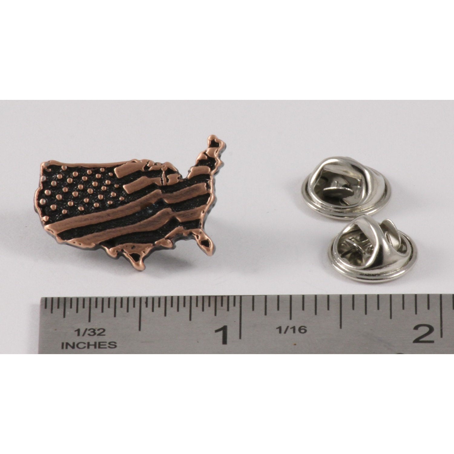 A handcrafted American Flag In Usa Outline Small Pin next to a ruler, available for sale at Creativeartisan.com - the image offers a sense of scale