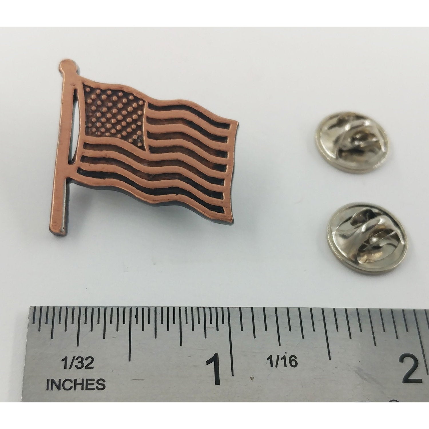 A handcrafted American Flag Waving Pin next to a ruler, available for sale at Creativeartisan.com - the image offers a sense of scale