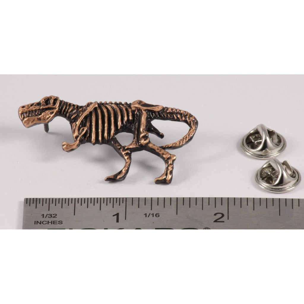A handcrafted Tyrannosaurus Rex Fossilized Body Pin next to a ruler, available for sale at Creativeartisan.com - the image offers a sense of scale