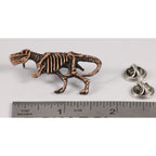 A handcrafted Tyrannosaurus Rex Fossilized Body Pin next to a ruler, available for sale at Creativeartisan.com - the image offers a sense of scale