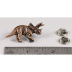 A handcrafted Triceratops Pin next to a ruler, available for sale at Creativeartisan.com - the image offers a sense of scale