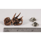 A handcrafted Triceratops Fossilized Head Pin next to a ruler, available for sale at Creativeartisan.com - the image offers a sense of scale