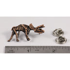 A handcrafted Triceratops Fossilized Full Body Pin next to a ruler, available for sale at Creativeartisan.com - the image offers a sense of scale