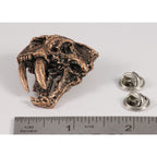 A handcrafted Saber Toothed Cat Skull Pin next to a ruler, available for sale at Creativeartisan.com - the image offers a sense of scale