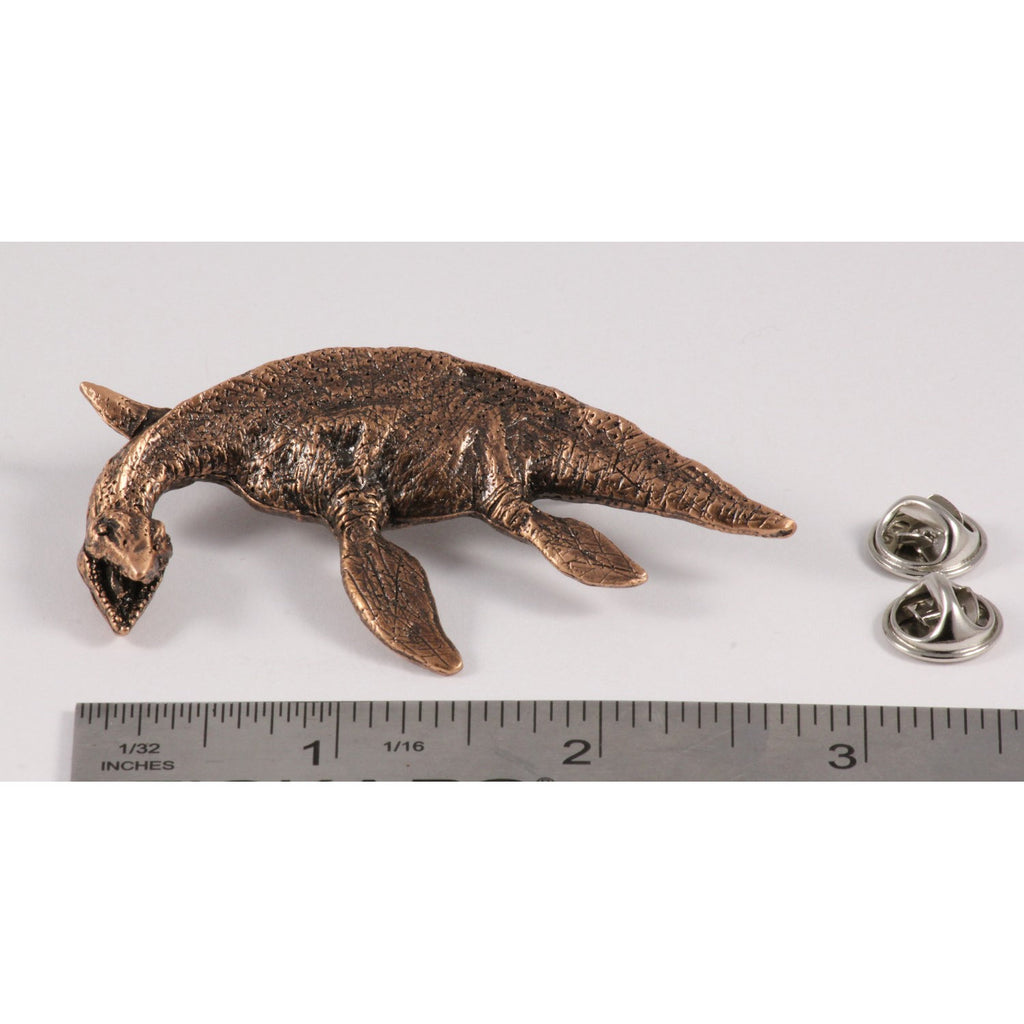 A handcrafted Elasmosaurus Prehistoric Marine Reptile Pin next to a ruler, available for sale at Creativeartisan.com - the image offers a sense of scale