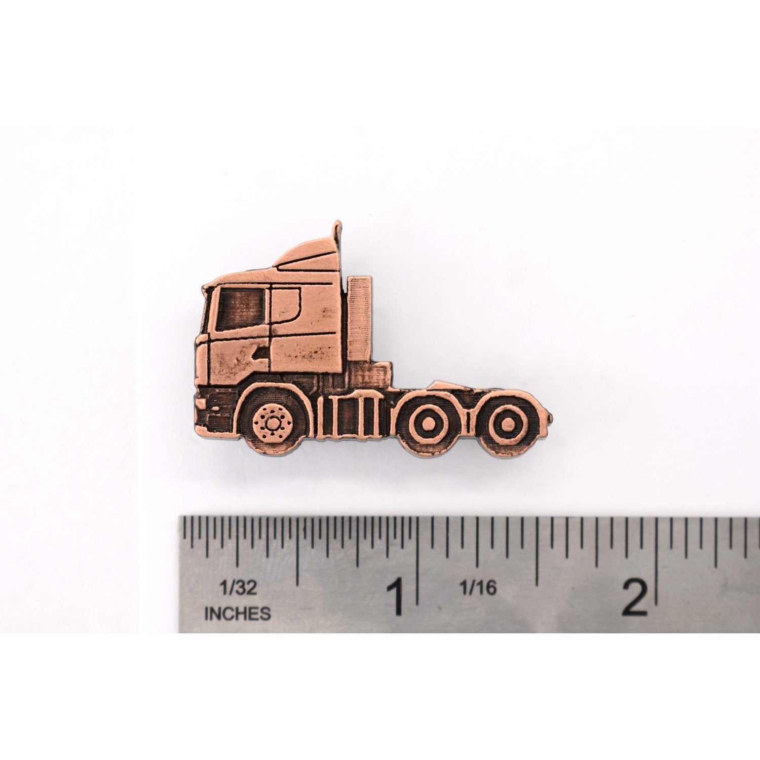 A handcrafted Semi Truck Short Nose Pin next to a ruler, available for sale at Creativeartisan.com - the image offers a sense of scale