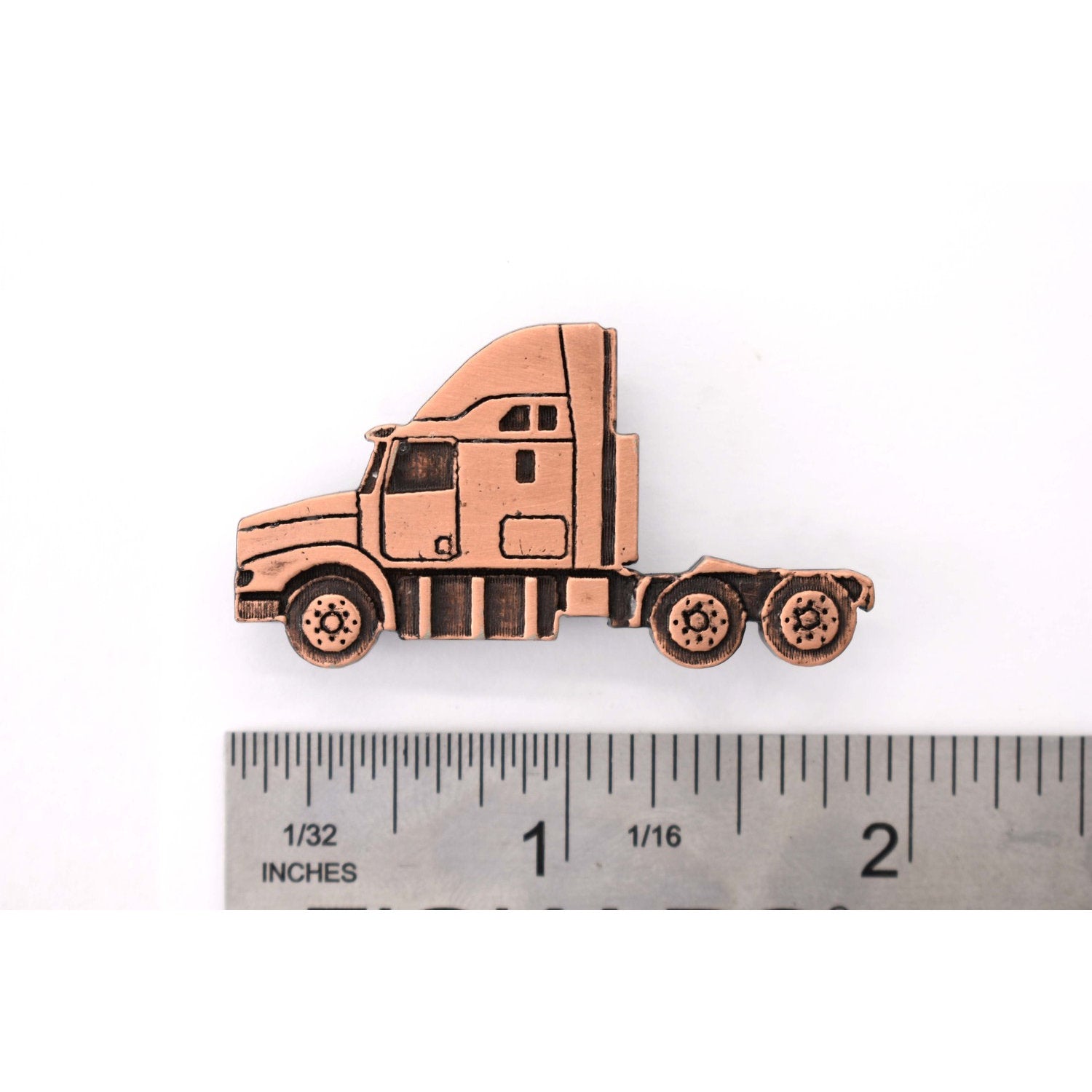 A handcrafted Semi Truck Long Nose Pin next to a ruler, available for sale at Creativeartisan.com - the image offers a sense of scale